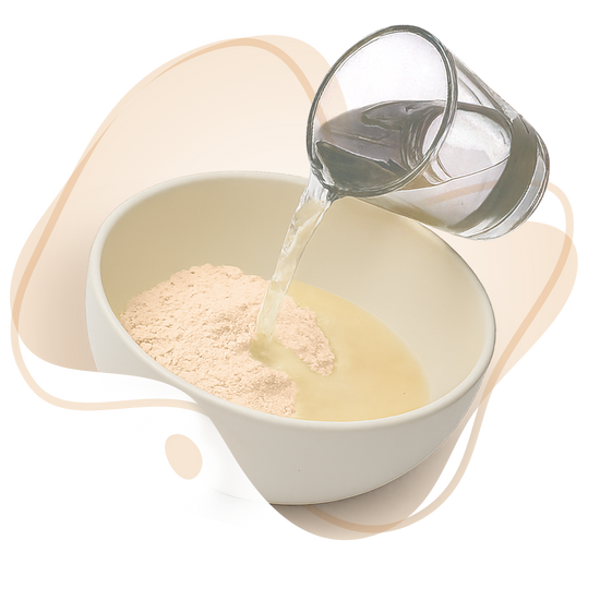 Glass pouring liquid into a bowl with a scoop of powder, on a white background