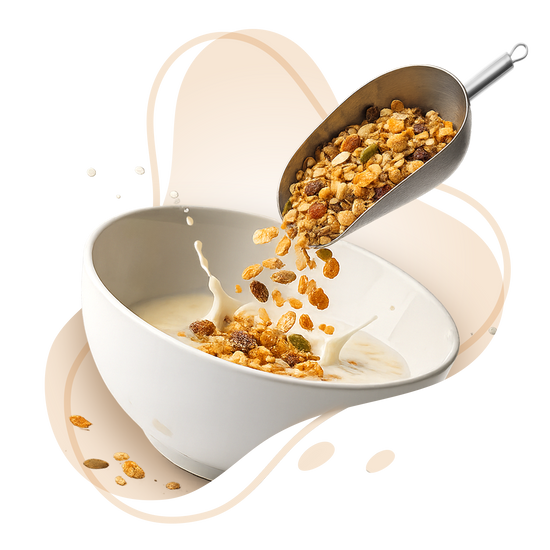 Cereal being poured into a bowl with milk, featuring a scoop of cereal.