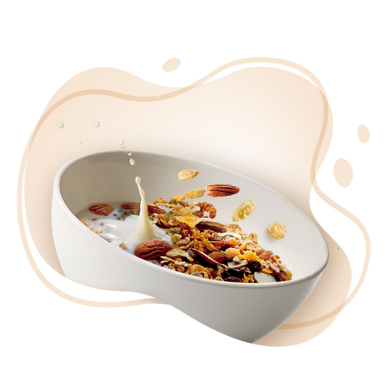 Bowl of cereal with milk and scattered cereal pieces on a white background